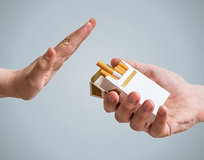 Hand held flat to turn down the offer of a generic cigarette