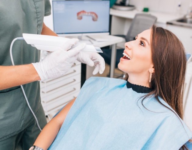 Dentist about to take digital impressions of teeth during dental checkup