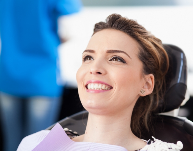 Smiling woman sitting back in dental chair