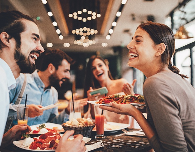Bonding patient in Castle Rock smiling with partner while at restaurant