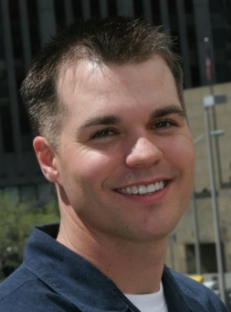 Man with short black hair smiling after dental work