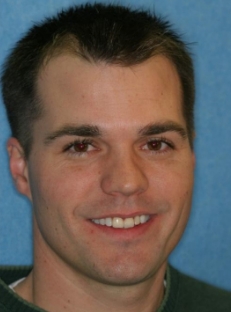 Man with short black hair smiling before dental work