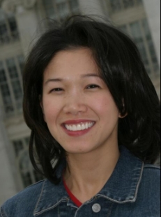 Woman in blue jacket smiling after dental work