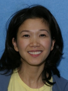 Woman in blue jacket smiling before dental work