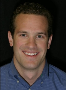 Man with curly hair smiling before dental work