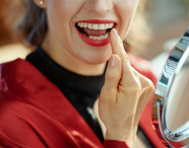 Lady admires her dental crown