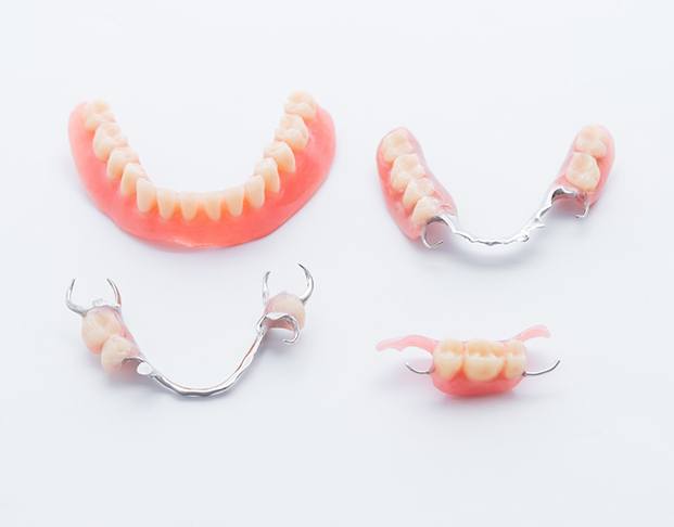 Partial and full dentures on white background
