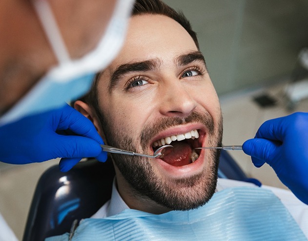 Man with brown hair having undergoing dental exam