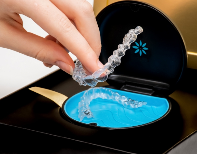 Person placing an Invisalign aligner in its case