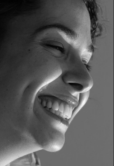 Close up side profile of smiling woman