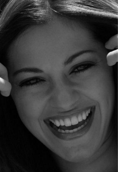 Close up of woman with long dark hair grinning