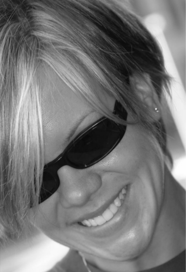 Smiling woman with short hair wearing sunglasses