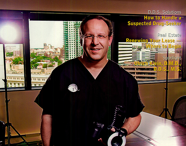 Doctor Radz holding dental microscope in classroom