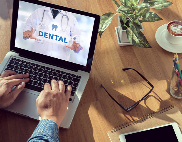 Person looking at dental plan information on laptop