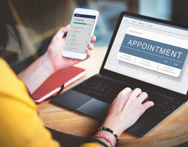 Woman scheduling a dental appointment in Castle Rock on laptop