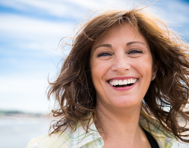 Woman with long brown hair grinning