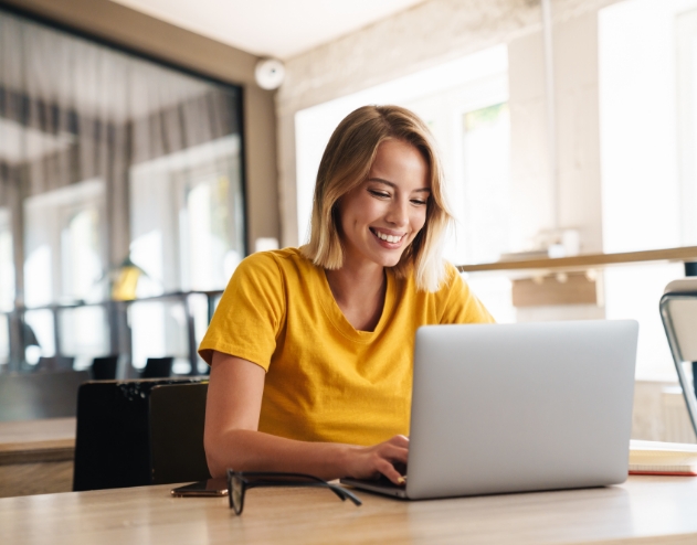 Woman looking at laptop for dentist reviews in Castle Rock