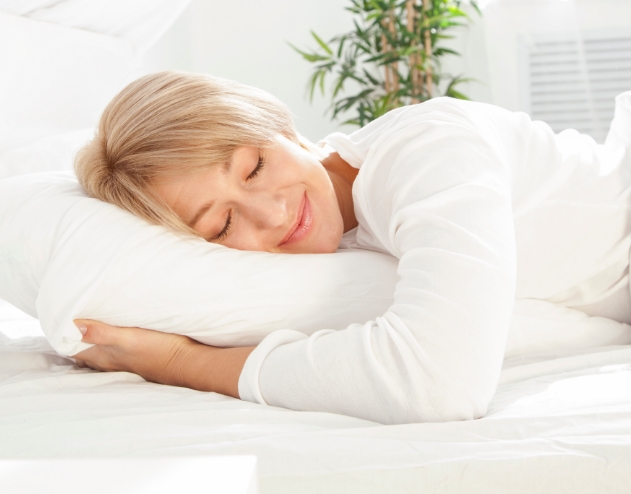 Woman in white blouse sleeping on her side