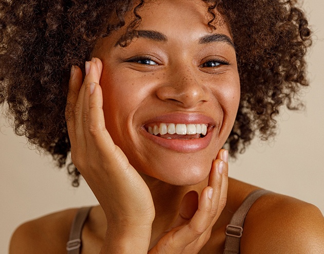 Woman with straight, white teeth smiling