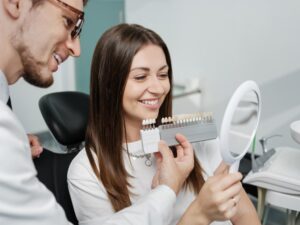 Woman getting veneers in dentist's chair.
